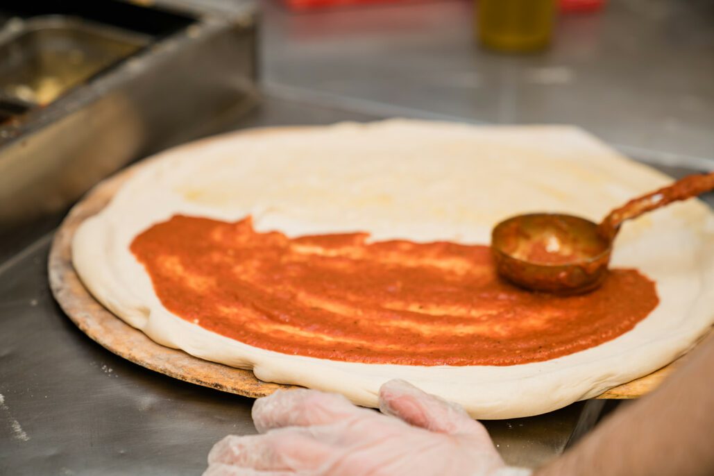 sauce is added to a pizza dough