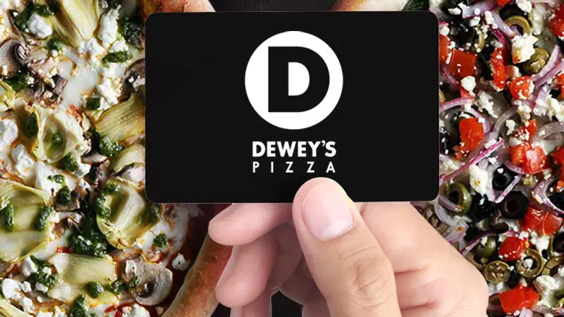 a Dewey's Pizza gift card being held by a hand. pizzas appear in the background.